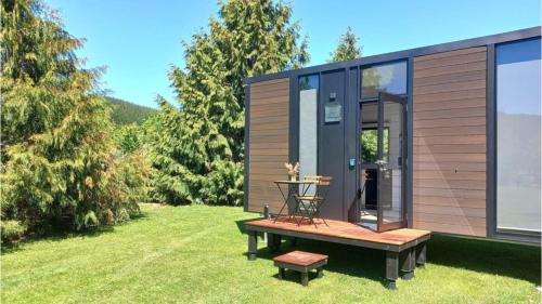 a tiny house with a picnic table in a yard at Ryan's Ranch by Tiny Away in Belgrove