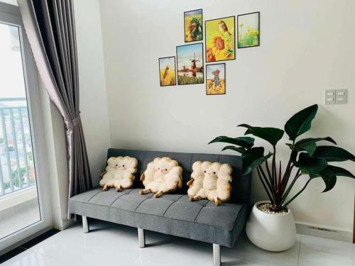 four dogs sitting on a couch in a living room at Nắng Home in Phan Rang