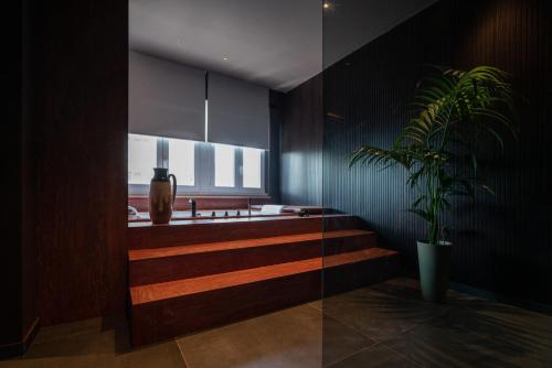 a bathroom with a staircase and a potted plant at Le Dimore - Ponte 7 in Palermo
