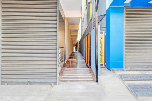 a hallway of a building with stairs leading down at Super Hotel O Yeshwanthpur Formerly Stay Comforts in Bengaluru