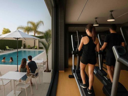 a group of people walking down a treadmill toward a pool at Executive Sport in Totana
