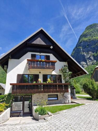 a house in the mountains with a balcony at Apartments and rooms Nataša 2 in Trenta
