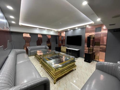 a living room with a couch and a tv at Numt Guren Resort in Ulaanbaatar