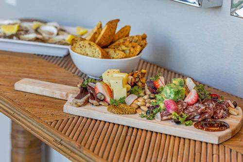 a plate of food on a table with a bowl of bread at Cambria Hotel Burbank Airport in Burbank