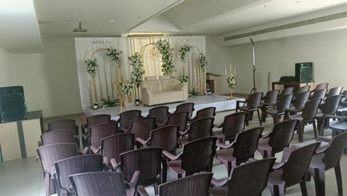 a room with rows of chairs in front of a stage at kmslegacy in Jāmb