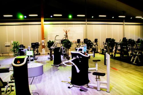 a gym with a lot of chairs and machines at Sportpark Reken Apartment III in Reken