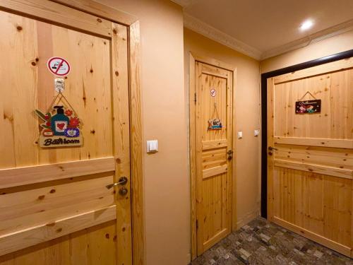 a hallway with two wooden doors in a room at Anna's guesthouse in Rīga