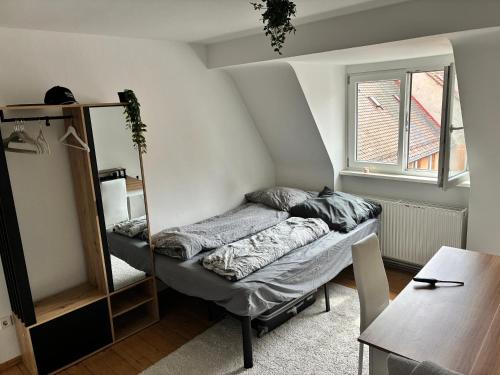 a room with two beds and a table at Holidays loft, Private Rooms in a Friendly shared apartment in Nürnberg