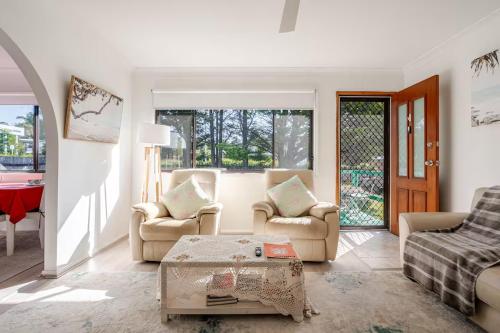 a living room with chairs and a coffee table at All in One Home Work, Relax & Weekend Escape in Bomaderry