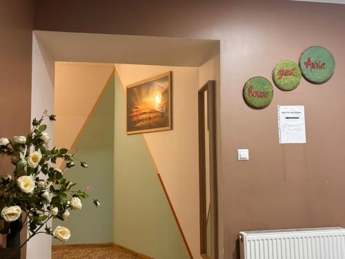 a hallway with green walls and a painting on the wall at Anna's guesthouse in Rīga