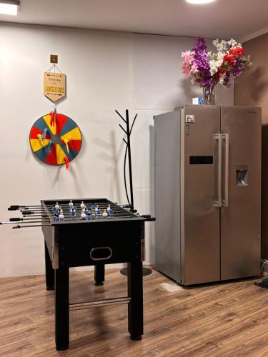 a chess table in front of a refrigerator at Anna's guesthouse in Rīga