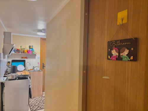 a door to a kitchen with a sign on it at Anna's guesthouse in Rīga