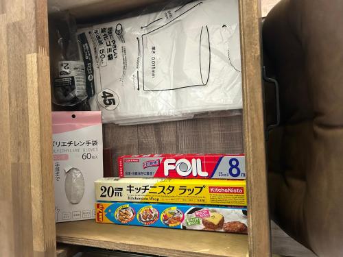 a shelf with boxes of food on it at とっくりhouse in Takashima