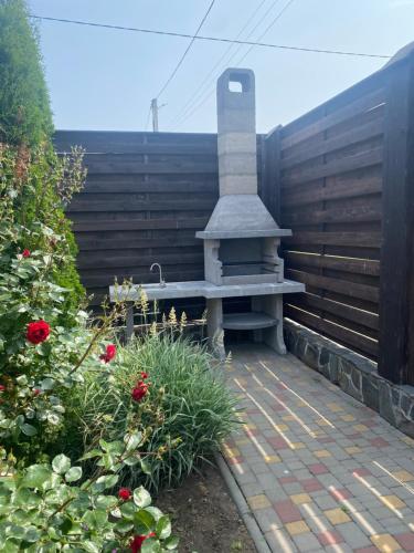 a stone bench sitting on a patio with flowers at Lazur Hills in Sanzhiyka