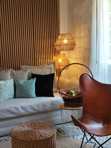 a bedroom with a bed and a chair and a lamp at Habitaciones Casa de Campo Daymipaz in Mahón
