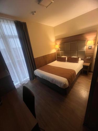 a hotel room with a bed and a window at OZO Hotels Cordial Amsterdam in Amsterdam