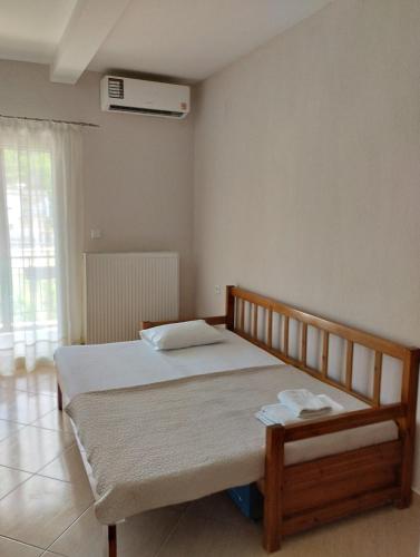 a bedroom with a bed and a window at Christina Apartment in Stavros