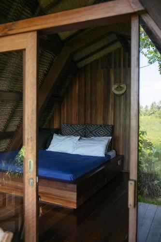 a bed in a gazebo on a deck at Coconut Corner - Rice Field Dome in Tanah Lot