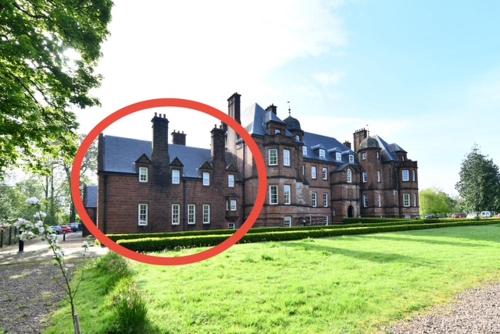 a red circle in front of a large building at 20 The Courtyard, Ballochmyle House in Mauchline