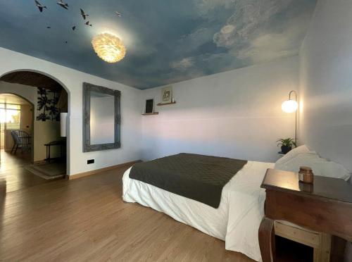 a bedroom with a bed and a ceiling with birds on it at Palm Oasis Guest House in Dubai