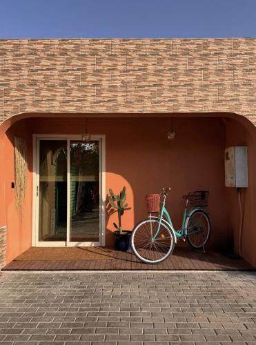 a bike parked next to a building at Palm Oasis Guest House in Dubai