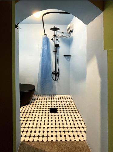 a bathroom with a shower with a tiled floor at Palm Oasis Guest House in Dubai