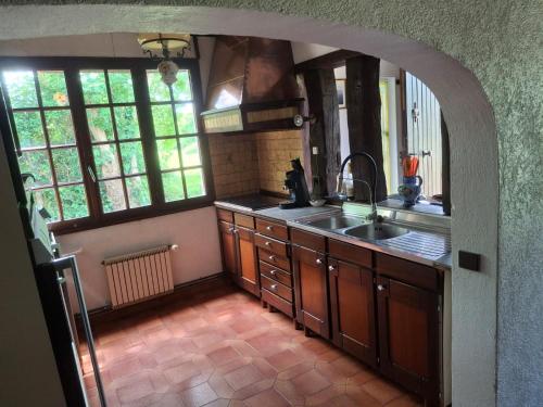a kitchen with a sink and a counter top at La petite maison normande in Honfleur