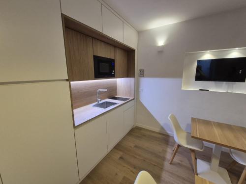 a kitchen with a sink and a table with chairs at Civico 41 in Pettorano sul Gizio