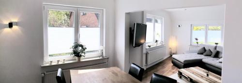 a living room with a couch and a table at Ferienhaus Strandallee 8 in Burhave
