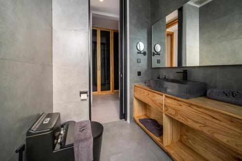 a bathroom with a sink and a mirror at Sunny Village Berawa in Canggu