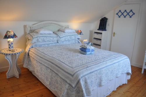 a bedroom with a bed and a table with a lamp at Lough Eske Retreat in Donegal