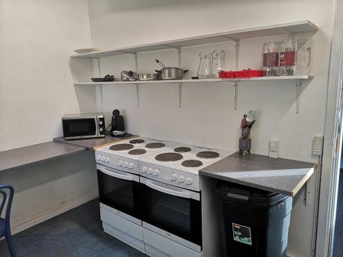 a kitchen with a stove and a counter top at Frederiksværk Camping & Hostel in Frederiksværk