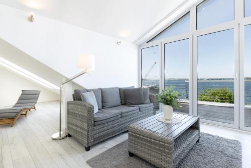a living room with a couch and a table at Strandweg 6-7 Strandhafer in Möltenort