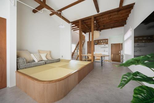 a living room with a couch and a table at Cube Sangenjaya in Tokyo