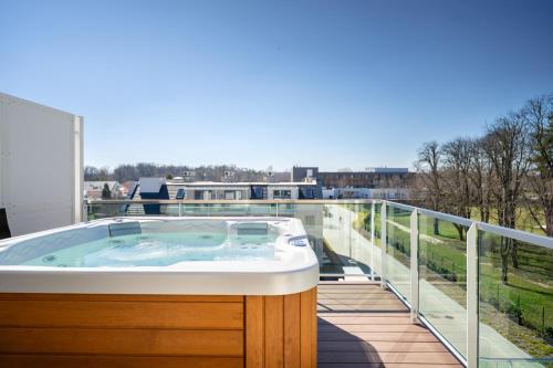 a hot tub on the balcony of a house at Onyx Luxury in Sárvár