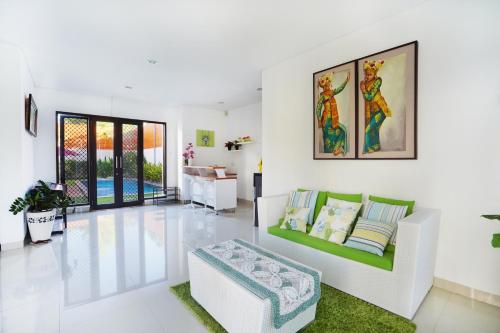 a living room with a couch and a table at Mahabrahma Villa in Uluwatu