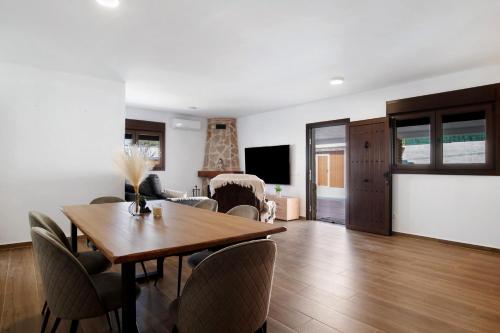 a living room with a wooden table and chairs at Casa La Teja 2 - Solo Familias in Vejer de la Frontera