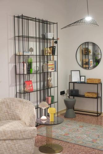 a living room with a chair and a mirror at AD ASTRA Comfort Living in Preveza