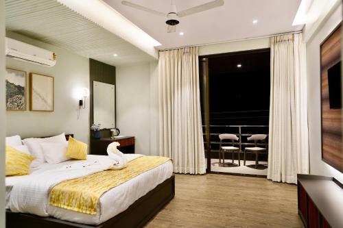 a bedroom with a bed with a swan sitting on it at Bhumiputra stays in Pernem