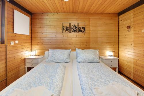 two beds in a sauna with wooden walls at Ferienhaus 10 Rechbergblick in Bernau im Schwarzwald