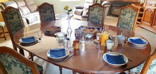 a dining room table with blue and white dishes on it at La Grande Vesvre in Gigny