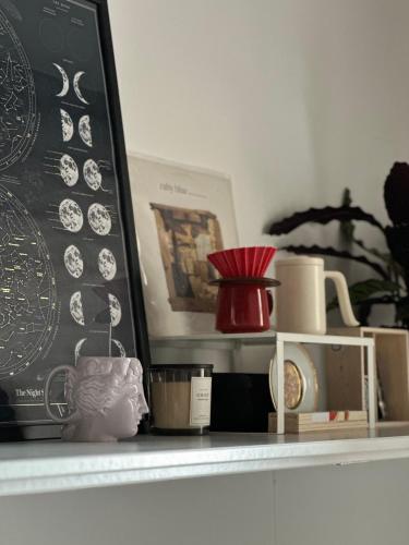 une étagère avec un tableau noir avec de la vaisselle dessus dans l'établissement Elegant Flat in Marais Paris, à Paris