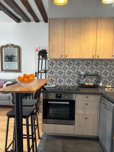 une cuisine avec une table et une cuisinière four supérieur dans l'établissement Elegant Flat in Marais Paris, à Paris
