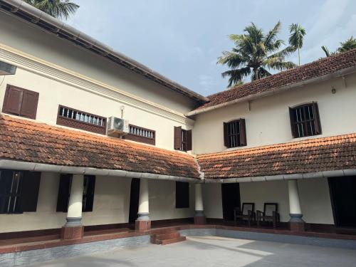 a view of the courtyard of a building at Kerala Heritage Private Pool Villa - Tharavad in Māla
