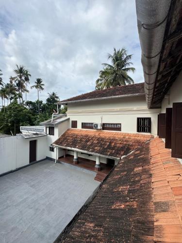 a building with a bench in front of it at Kerala Heritage Private Pool Villa - Tharavad in Māla