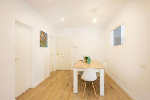 a white room with a table and two chairs at Lovely apartment with 3 bedroom in Cornellà de Llobregat