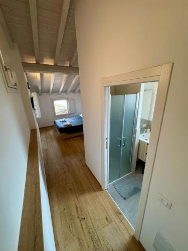 an empty room with a door to a bedroom at Loggia Tre Piazze Apartments in Brescia