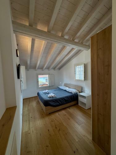 a bedroom with a bed and a wooden ceiling at Loggia Tre Piazze Apartments in Brescia