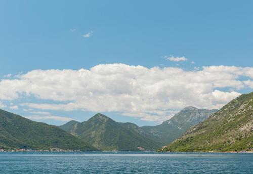 a view of a large body of water with mountains at Villa Blue Dream in Dobrota