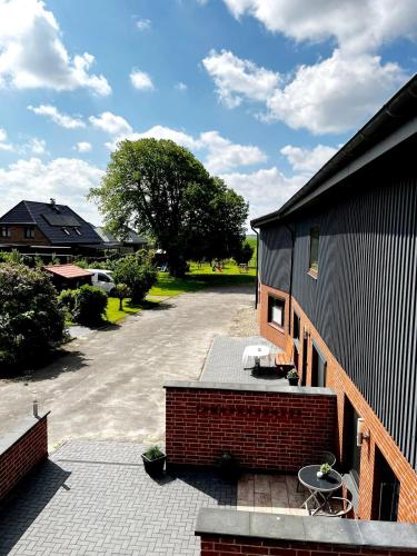 a patio with two chairs and a table next to a building at 3-Zimmerwohnung, 2 Bäder, Büsum (4km), Nordsee in Oesterdeichstrich